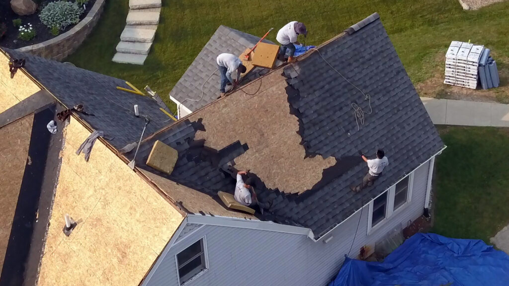 Shingle tear off crew on roof replacement job