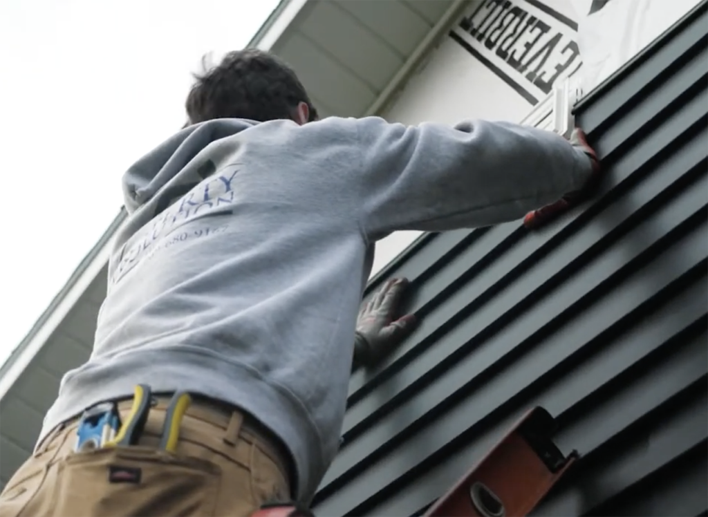 Siding repair crew installing new siding