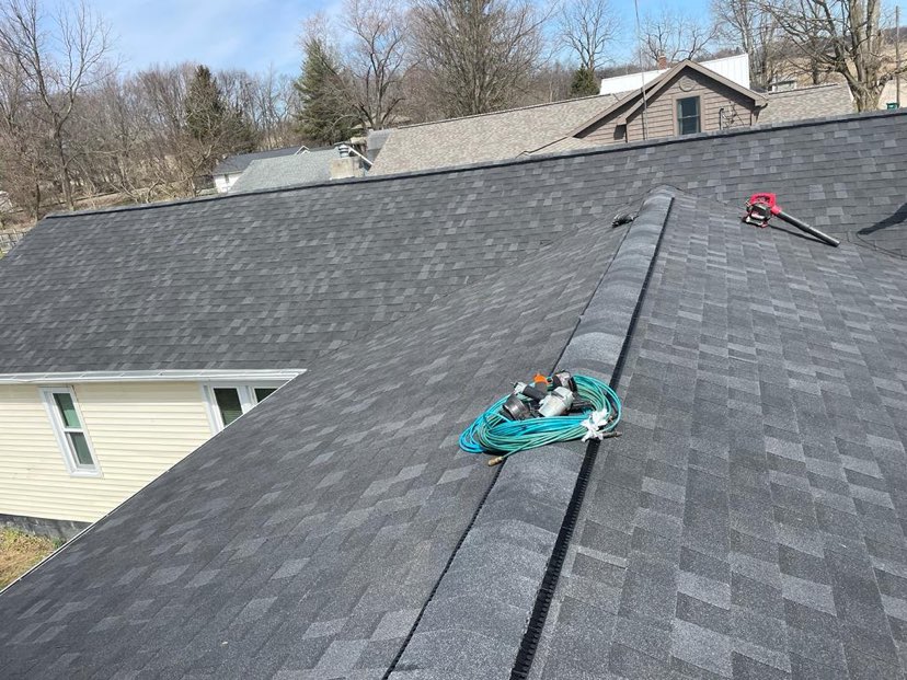 completed roofing project cleaning up