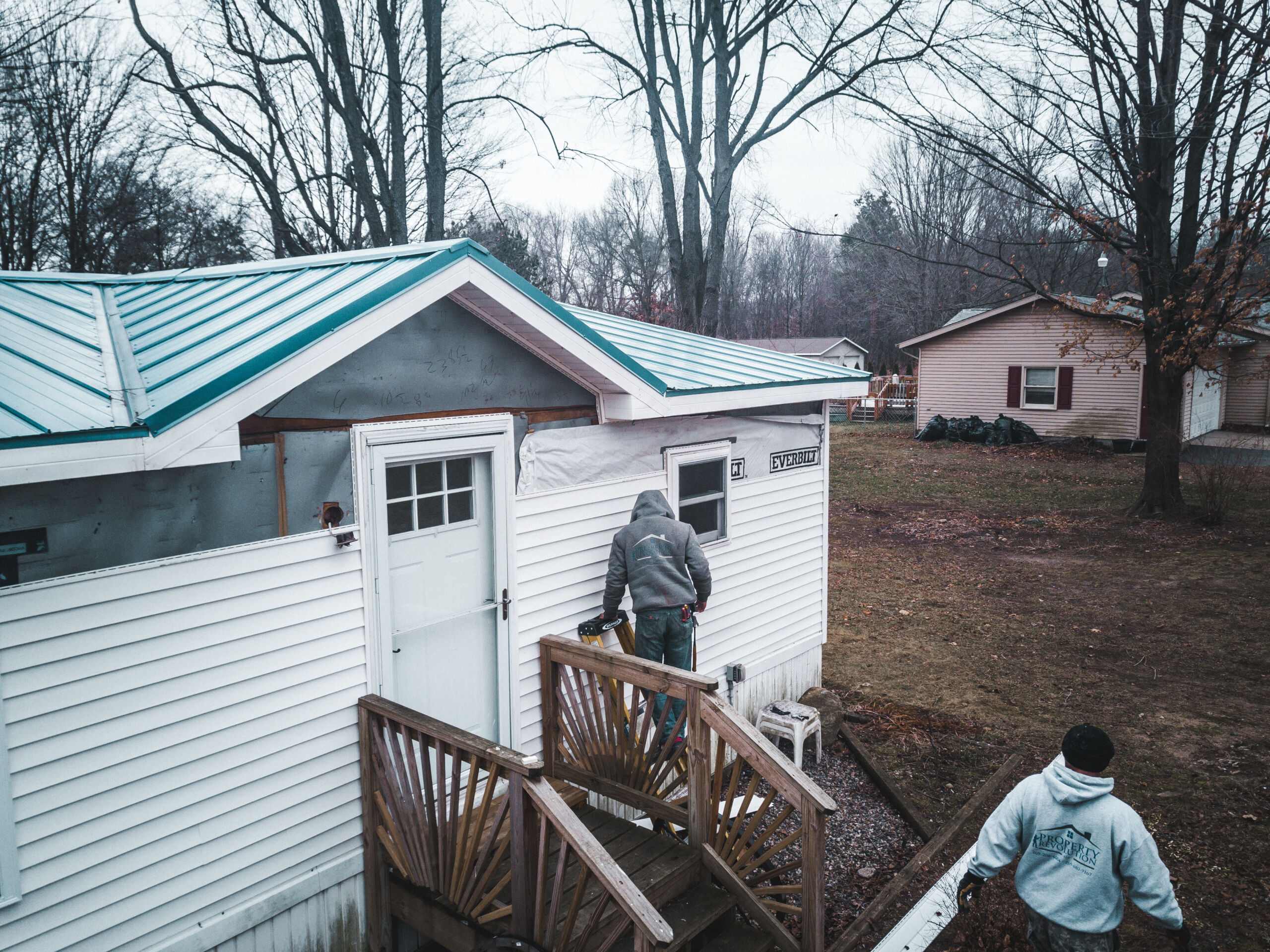 Siding crew working on house