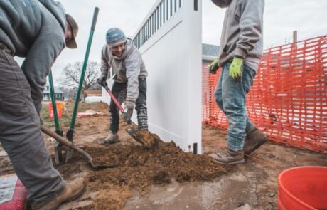 fence installation crew doing concrete