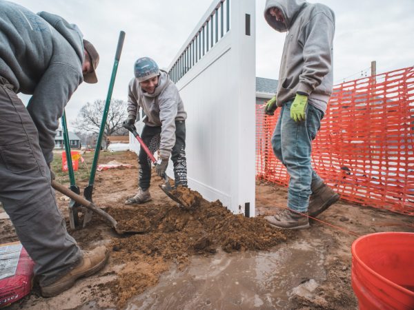 fence installation crew doing concrete